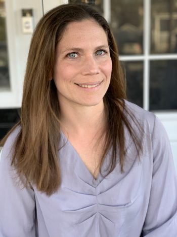 A headshot of woman wearing a light purple shirt